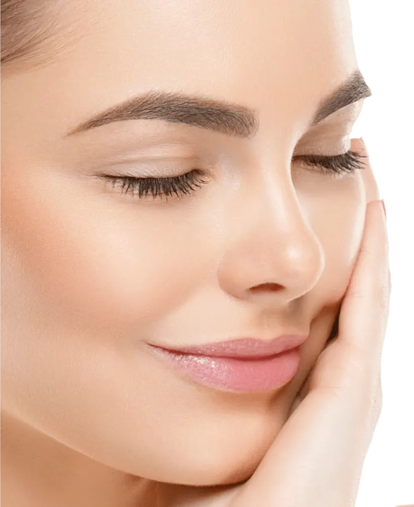 Woman with radiant skin gently touching her cheek